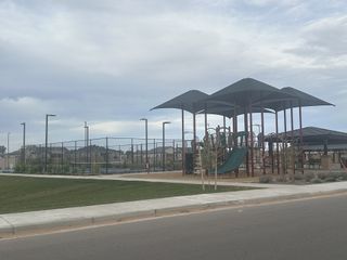 A vibrant playground with slides and canopy in Earnhardt Ranch by Blandford Homes (Chandler, AZ).