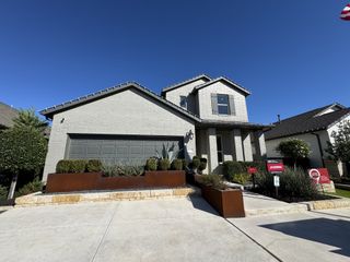 Street view Street View: A stylish gray brick home with modern shutters and lush landscaping in Turner's Crossing by Taylor Morrison (Buda, TX)