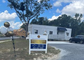 A welcoming sales center with balloons marks Sweetgrass Station by Dream Finders Homes in Summerville, SC.