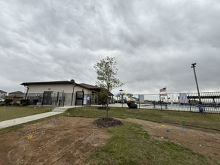 A community center and pool with slides in Riverstone at Westpointe by D.R. Horton, San Antonio, TX.