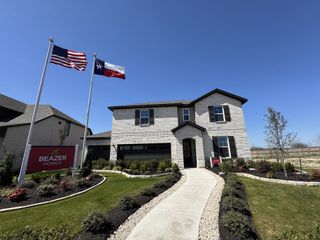 A beautiful two-story brick home with landscaped yard in Venado Crossing by Beazer Homes (Cibolo, TX).