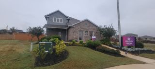 Street view Charming brick home with lush landscaping in Cinco Lakes by Legend Homes, San Antonio, TX.