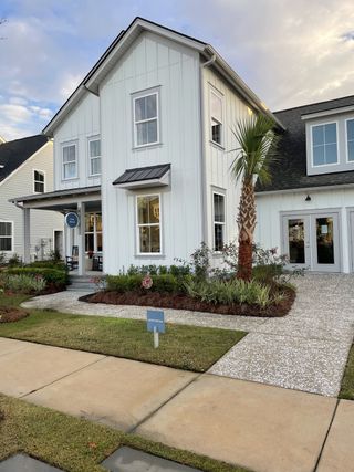 Charming white home with a landscaped yard in Nexton by Pulte Homes, Summerville, SC.