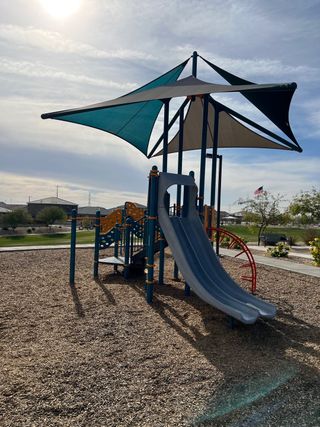 Community Amenities A vibrant playground with shaded slides and climbing structures in the Village at Sundance by Centex (Buckeye, AZ).