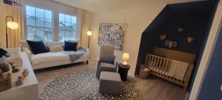 A cozy nursery with soft tones, plush seating, a crib, and playful animal decor, perfect for a serene child's space.