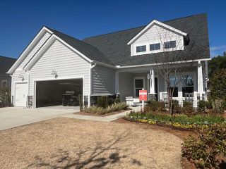 A charming gray and white home with a spacious garage in Horizons at Summers Corner by Lennar (Summerville, SC).