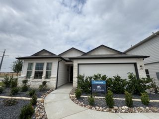 A charming modern home with a sleek driveway and landscaped garden in Clear Spring Meadows by M/I Homes (New Braunfels, TX).