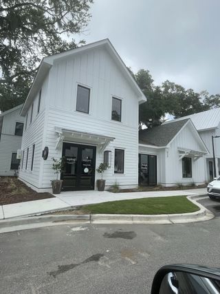 Street view Charming white home with modern design in Hayes Park by New Leaf Builders (Johns Island, SC).