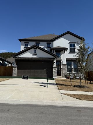Street view A modern two-story home with a spacious driveway in Lakeside at Tessera on Lake Travis by Saratoga Homes (Lago Vista, TX).