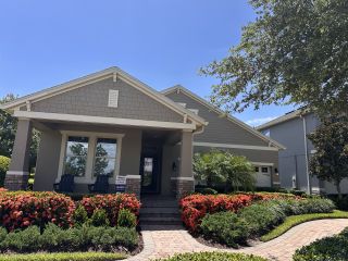 Charming gray home with lush landscaping in Waterleigh by D.R. Horton, Winter Garden, FL.
