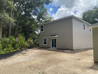 A modern tan siding home with a spacious yard in Whistler Woods by Lennar (Jacksonville, FL).