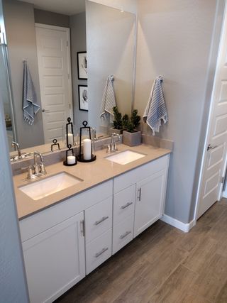 A modern bathroom featuring dual sinks, sleek cabinetry, and stylish accents for a clean, contemporary look.