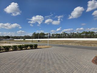 A spacious, open landscape with clear skies in Tidewater by ICI Homes, Jacksonville, FL, showcasing modern suburban development.