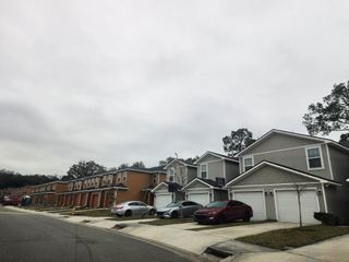 Street view Modern townhomes with garages and neatly lined driveways in Lakeside Townhomes by Lennar (Jacksonville, FL).