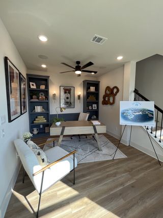 A bright and modern home office with built-in shelving and contemporary decor in Solterra by David Weekley Homes (Mesquite, TX).