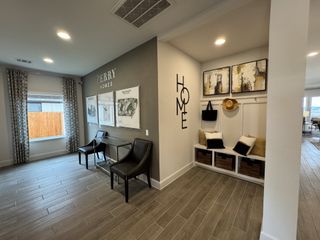A welcoming entryway with custom storage, warm accents, and stylish decor in Veramendi by Perry Homes (New Braunfels, TX).