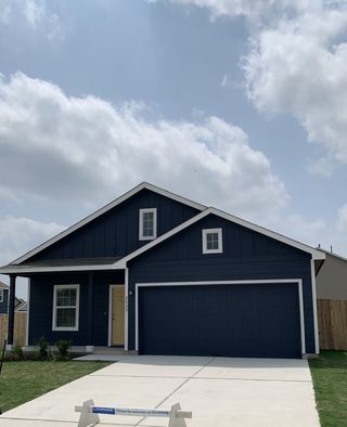 Street view A modern blue home with a spacious driveway in Greenwood by Lennar, Pflugerville, TX.