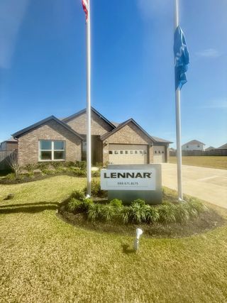 A spacious Lennar model home in Samara (League City, TX) with a three-car garage, beautiful landscaping, and an inviting exterior.