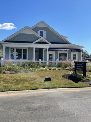 A beautiful gray shingle home with a manicured yard in Center Pointe by D.R. Horton (Santee, SC).