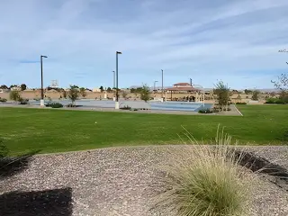 A scenic community park with lush lawns and sports courts in Combs Ranch Discovery Collection by Taylor Morrison (Queen Creek, AZ).