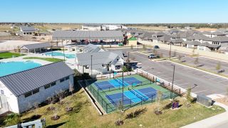 Community Amenities A vibrant community center with pools and sports courts in Santa Rita Ranch by Scott Felder Homes (Liberty Hill, TX).