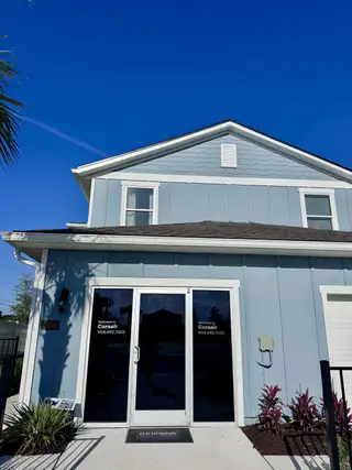 Street view A charming blue home with modern design features in the Corsair community by D.R. Horton (Middleburg, FL).
