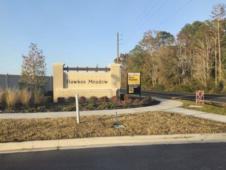 Street view A welcoming entrance sign for Hawkes Meadow by KB Home, surrounded by manicured landscaping in Jacksonville, FL.