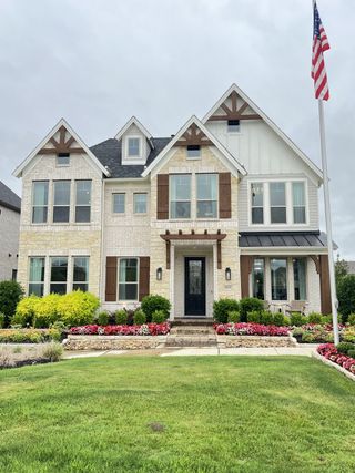 Charming white brick home with landscaped yard in Edgewater by Grand Homes (Fate, TX).