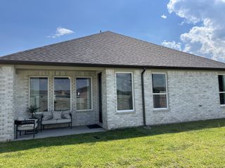 A beautiful white brick home with a cozy patio in Alexander by D.R. Horton, Pearland, TX.