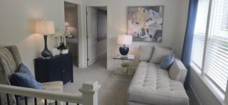 A cozy living space with a plush sectional, abstract art, and modern decor, inviting relaxation and comfort.