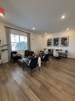 A cozy living space with wood floors, modern art, and elegant seating.