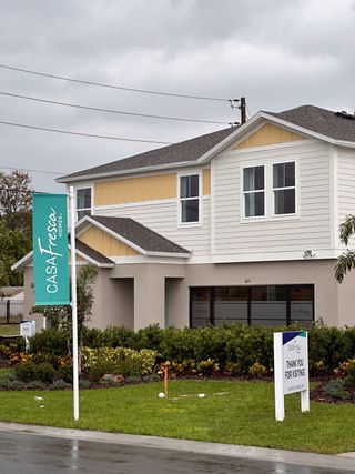 A charming two-story home with a landscaped yard in Bradbury Creek by Casa Fresca Homes (Haines City, FL).