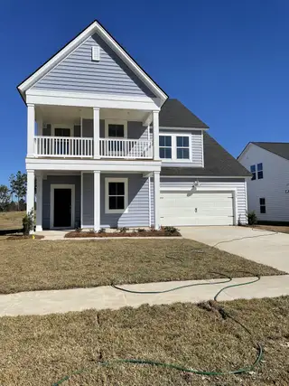 Street view A charming two-story home with a spacious porch in Heron's Walk at Summers Corner by Lennar (Ridgeville, SC).
