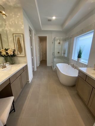 Elegant bathroom featuring a freestanding tub, spacious vanity, and modern decor with soft lighting accents.