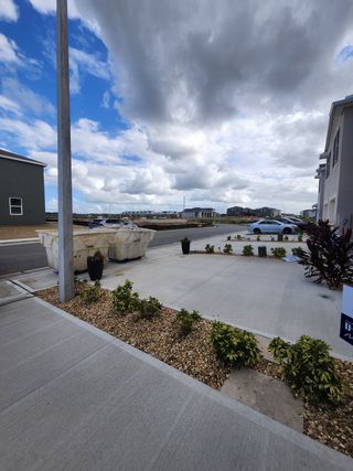Modern townhome exteriors with clean landscaping in Brentwood Townhomes by D.R. Horton (Davenport, FL).