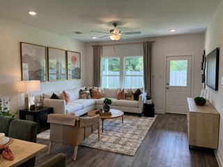 A cozy living room with a sectional sofa, modern art, soft lighting, and a rustic coffee table.