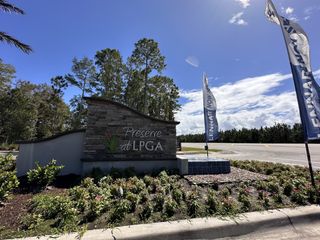 A welcoming entrance sign surrounded by lush landscaping in Preserve at LPGA by Lennar (Daytona Beach, FL).