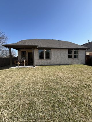 A charming brick home with a spacious backyard and covered patio in Lake Pointe at Paloma Creek by Beazer Homes (Little Elm, TX).