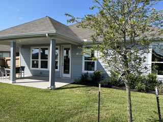 A charming home with a cozy patio and landscaping in Imperial Forest by KB Home (Alvin, TX).