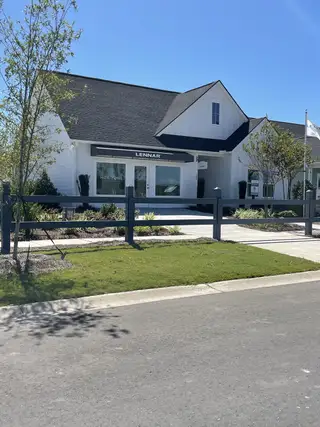 Charming white home with modern landscaping in Horizons at Carnes Crossroads by Lennar (Summerville, SC).