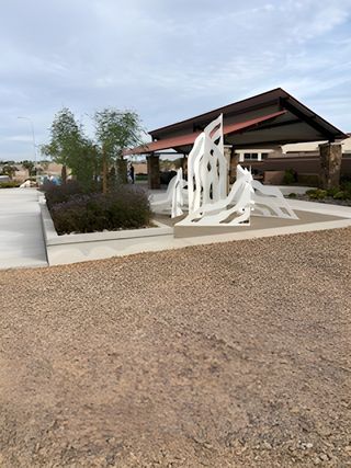 A modern pavilion with artistic sculptures and greenery in Alamar: Premier by Lennar (Avondale, AZ).