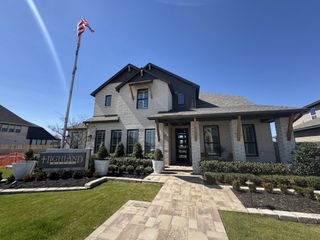 A beautiful brick home with manicured landscaping in Venado Crossing by Highland Homes (Cibolo, TX).