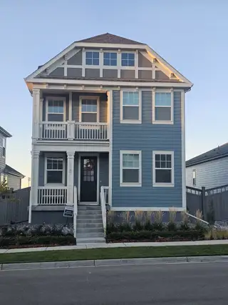 A charming blue two-story home with traditional details in Westerly by Brightland Homes (Erie, CO).