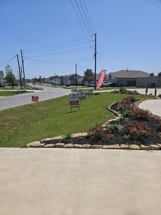 Charming neighborhood street view with landscaped yards in Santa Fe by Home Creations (Cleveland, TX).