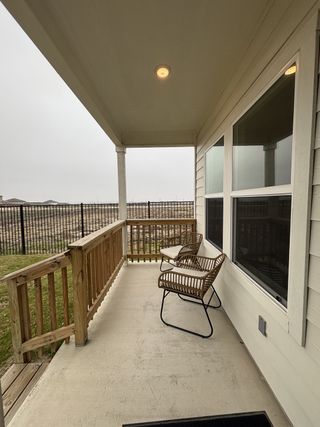 A welcoming porch area with comfortable seating and a scenic view of the surrounding area, perfect for relaxing.