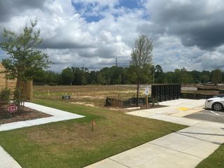 Street view Upcoming development site with greenery and mailboxes in Battle Bridge by DRB Homes in Raleigh, NC.