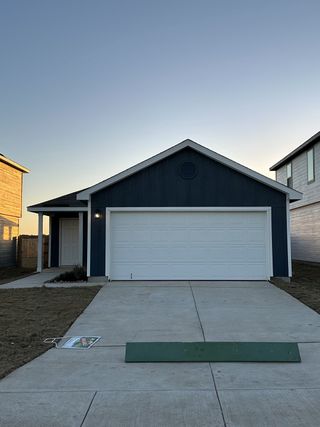 Charming blue home with a spacious driveway in Hidden Oasis by Lennar (San Antonio, TX).