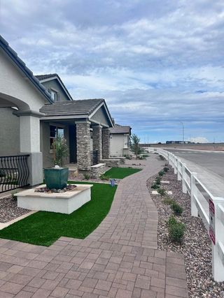 Charming stone-accented homes with manicured paths in Ridgeline at Acclaim by Fulton Homes (Avondale, AZ).