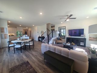 A contemporary open living area with hardwood floors, sleek furniture, and abundant natural light.