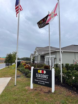A beautiful community entrance with manicured gardens in Seasons at Heritage Square by Richmond American Homes (Haines City, FL).